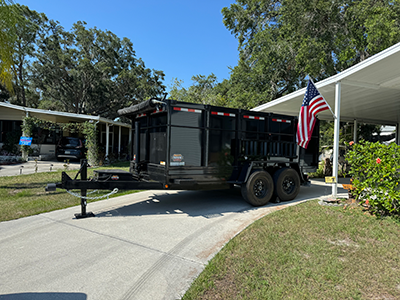 Dumpster trailer parked for roof removal.