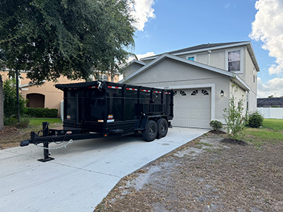 Dumpster parked for roof removal for a two story home.